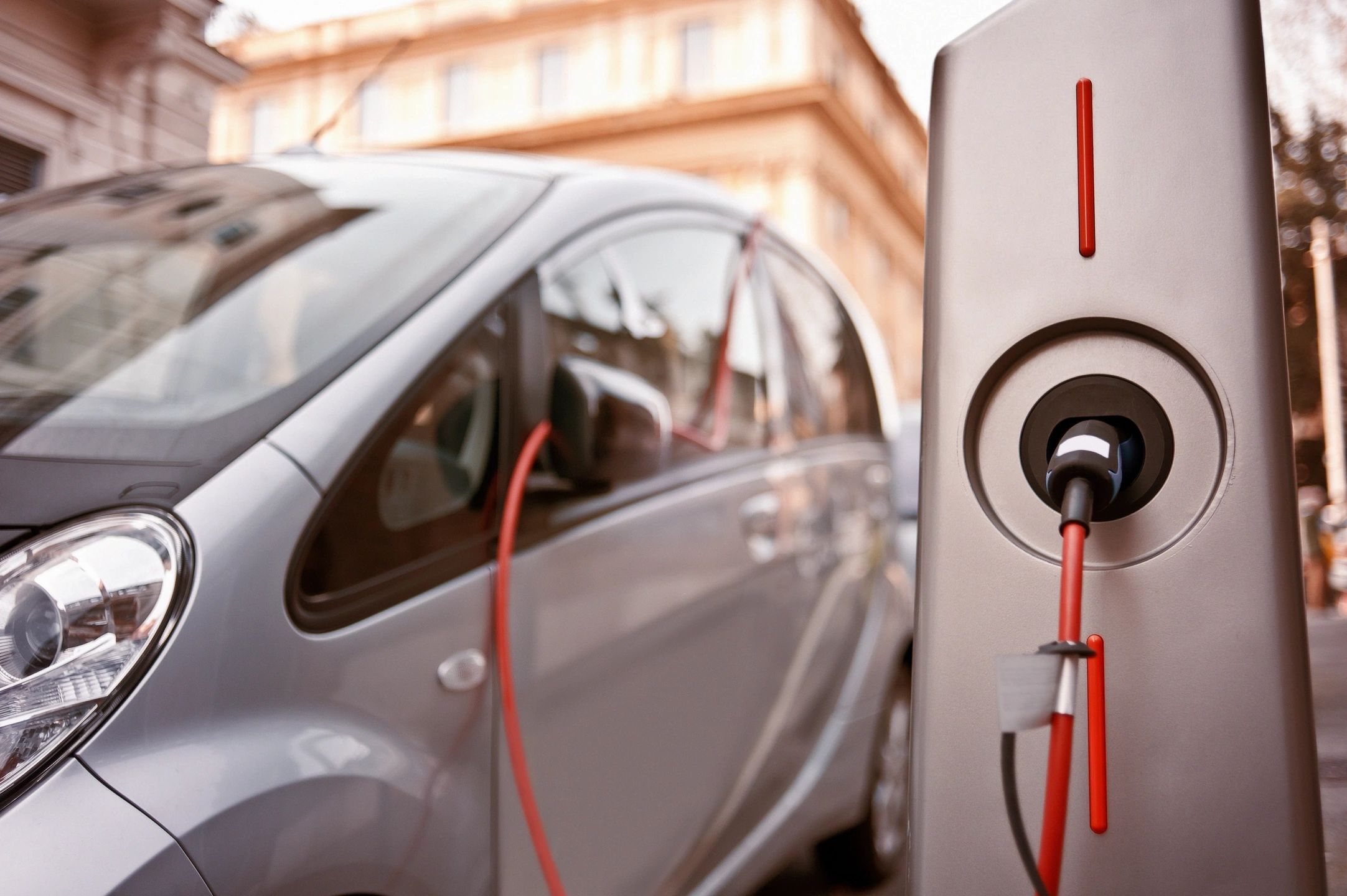 Electric vehicle plugged into a charging station and actively charging.