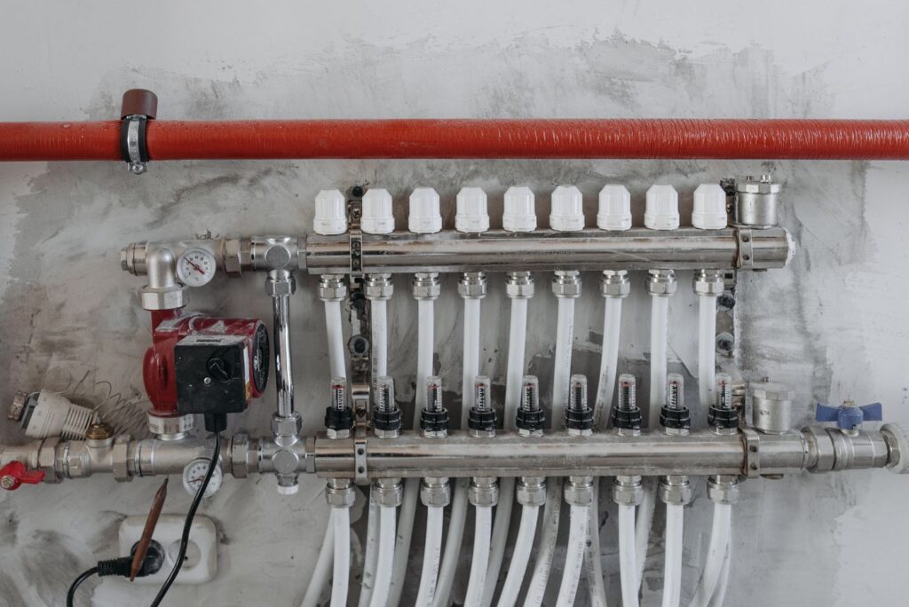 Modern PEX plumbing manifold with color coded distribution lines used in a whole house repipe