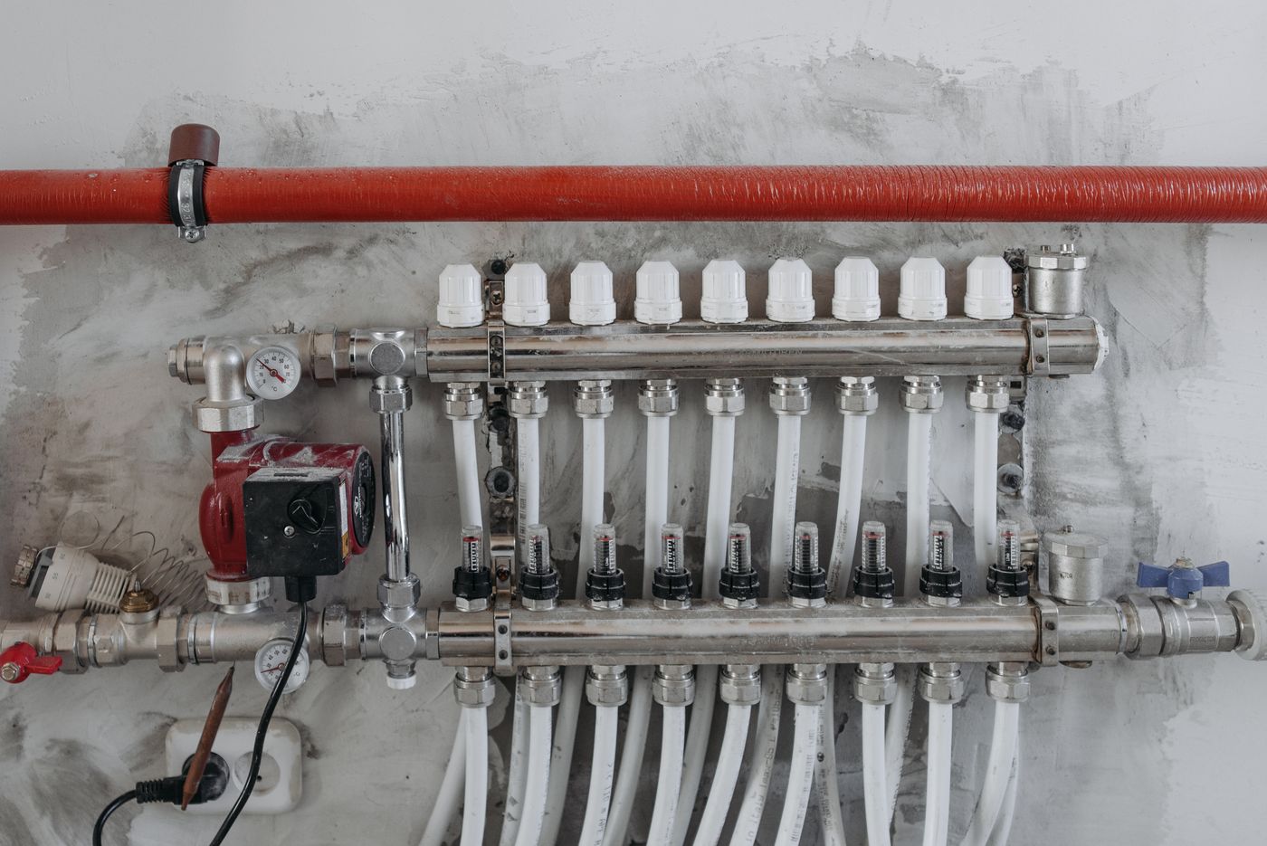 Modern PEX plumbing manifold with color coded distribution lines used in a whole house repipe
