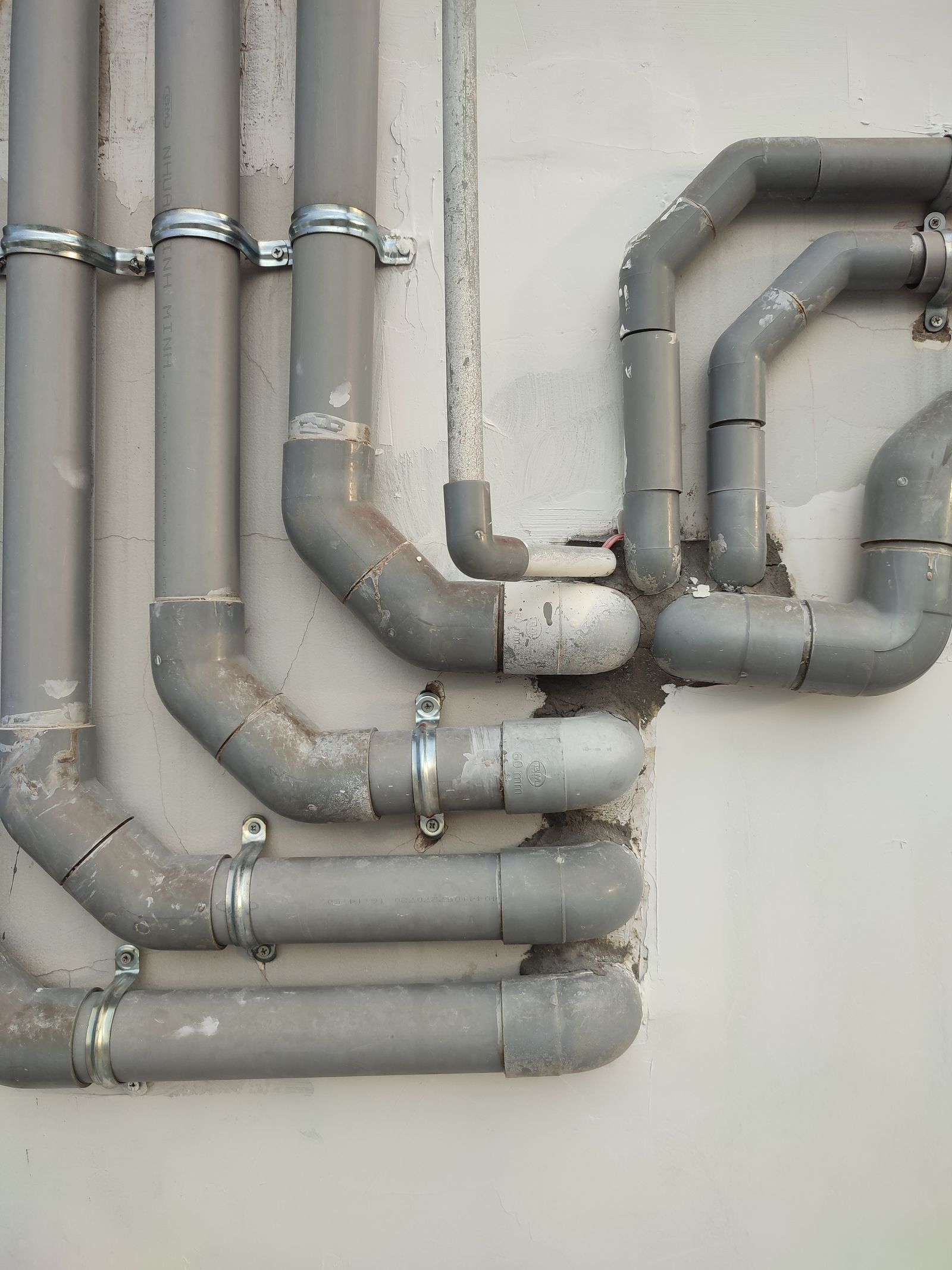 Network of home water supply pipes running along a wall during a whole house repiping project