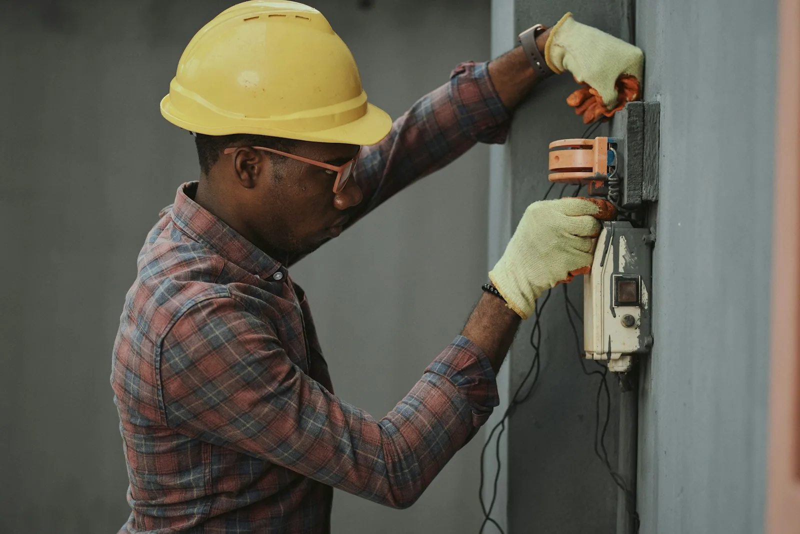 Electrician testing wiring at an electrical panel